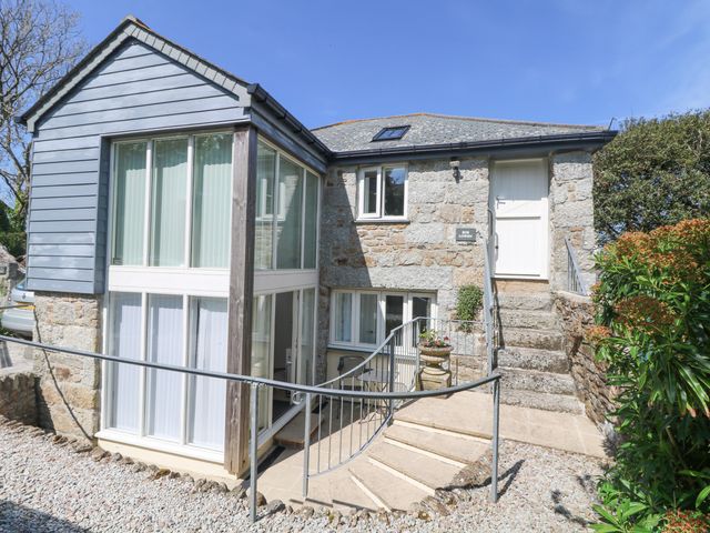 Exterior view of a stone house with blue cladding and large windows at Bos Lowen Paul near Mousehole