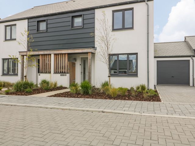 Front view of a modern semi detached house with small garden and paved driveway at Periwinkle in Crantock