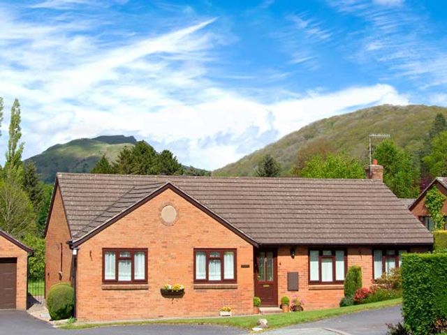 A single story brick house with windows and a door at Tregarthens in Church Stretton