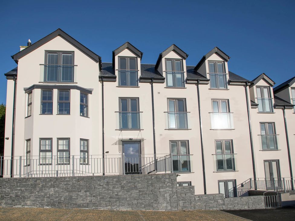 Exterior view of a multi-story building with multiple windows and balconies at Sea Breeze in Benllech