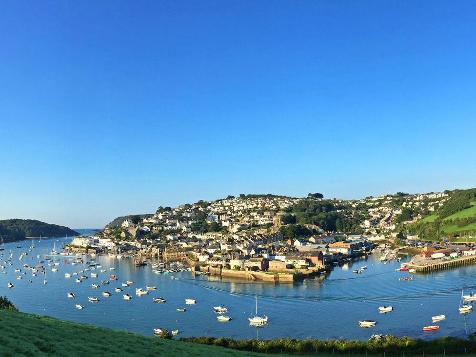 A coastal town with many houses on a hillside overlooking a harbor with boats at 34 The Salcombe in Salcombe
