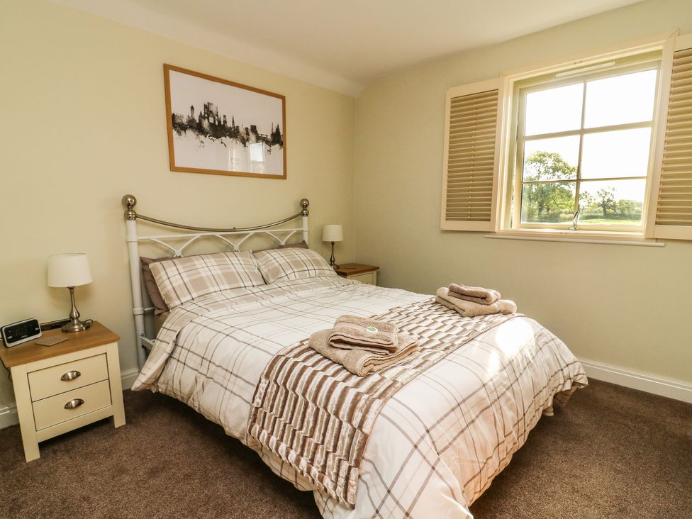 A bedroom with a double bed and bedside tables at Decca Cottage Nidd Grange in Moor Monkton near York