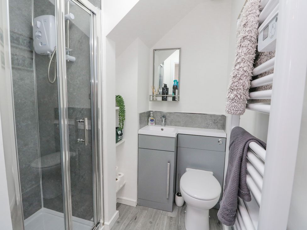A bathroom with a shower cubicle sink toilet vanity mirror and towel rack at Ben View in Tarbet near Arrochar