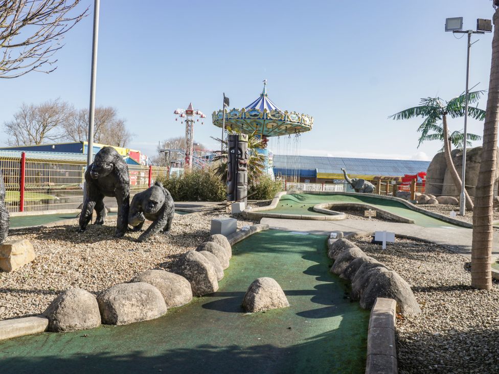 An outdoor mini golf course with animal statues and amusement park rides at Little Walton in Burnham-On-Sea