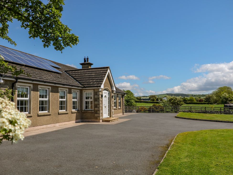 The exterior of a house with windows and a white door in a rural setting at Willow Tree Farm House in Newry near Jonesborough
