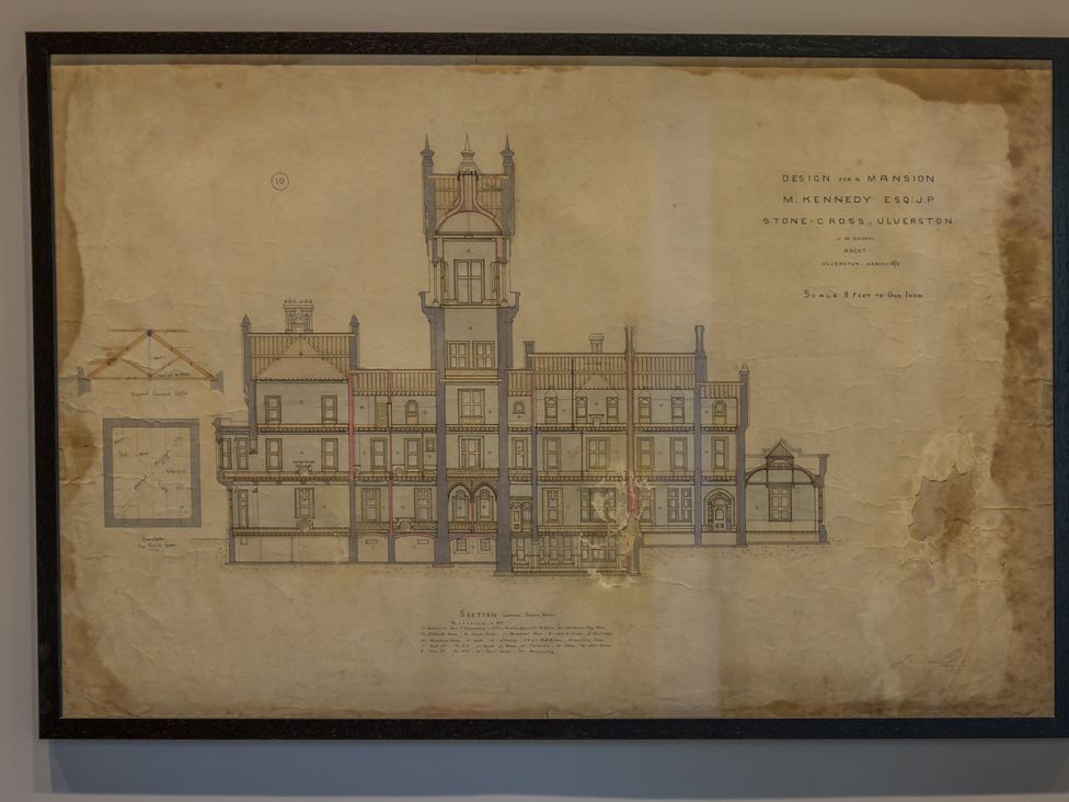 A vintage architectural blueprint of a mansion with detailed sections and notes at The Violet Suite Stone Cross Mansion in Ulverston