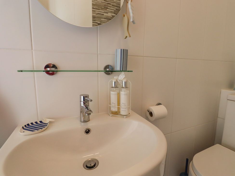 A bathroom sink with a faucet soap dispensers and a toilet paper roll at The Old Spy Headquarters in Folkestone
