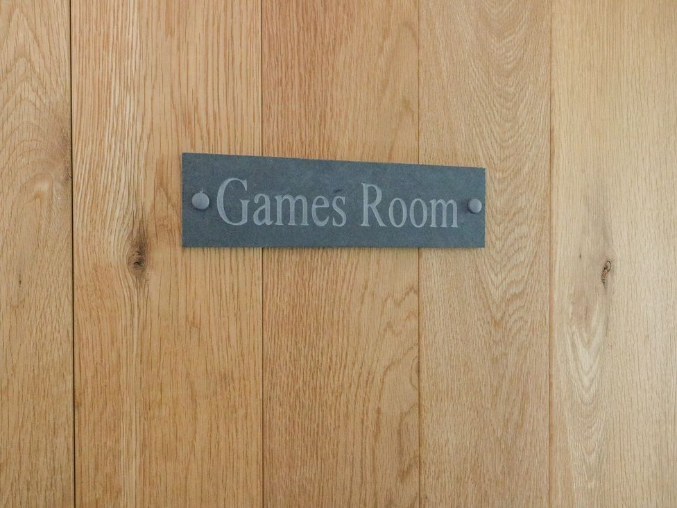 A wooden door with a sign that reads Games Room at Cae Du in Dwyran near Niwbwrch Newborough