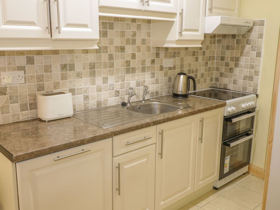 A kitchen countertop with a toaster kettle and stovetop at Glebe House in Ballinrobe County Mayo