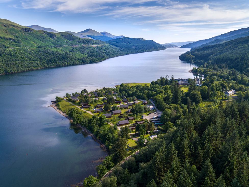 A lakeside village with houses surrounded by trees and mountains at Ardgartan Argyll Golden Oak Lochside in Ardgartan Loch Long