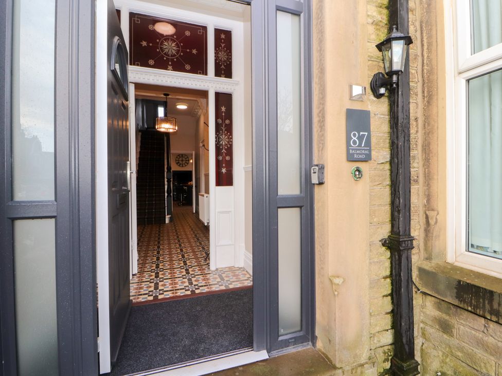 An open front door showing a tiled hallway with stairs inside a house at Inglemead in Morecambe