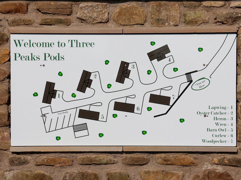 A map showing layout of seven pods and a car park at Three Peaks Pods