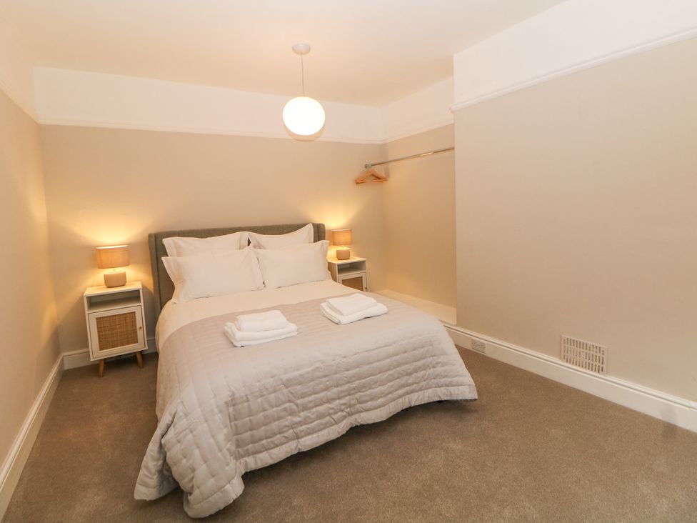 A bedroom with a bed and bedside tables with lamps at Spa House in Buxton