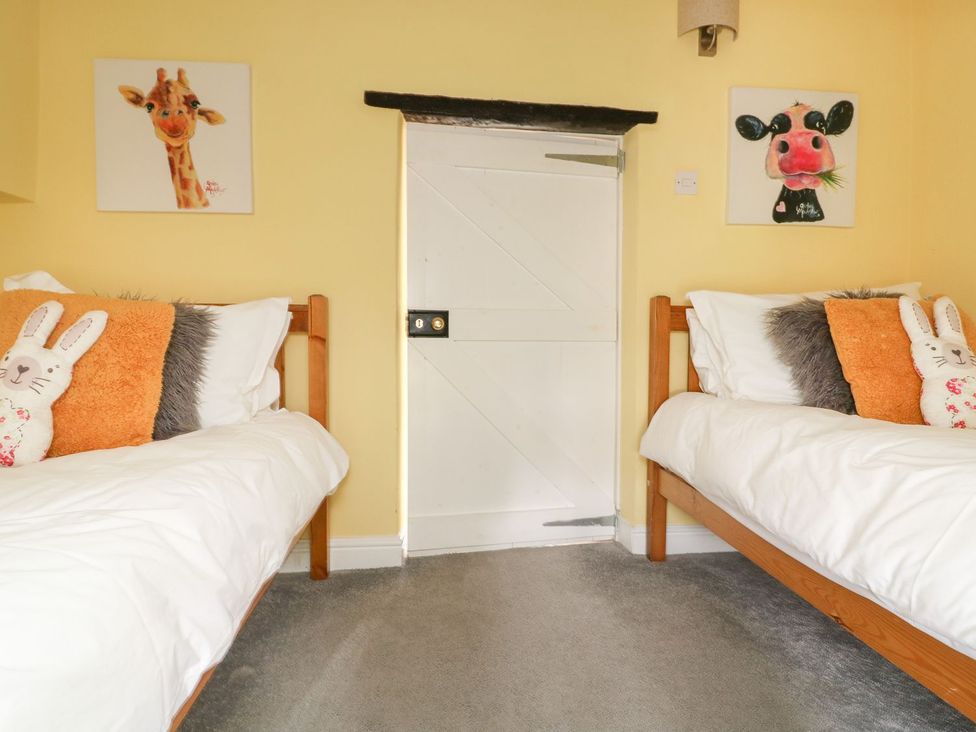 A bedroom with two single beds with stuffed rabbits on each at St Edmunds House in Crakehall