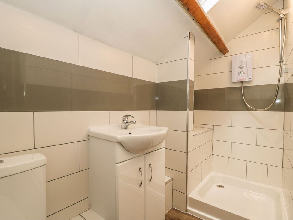A bathroom with a sink cabinet toilet and shower at St Edmunds House in Crakehall
