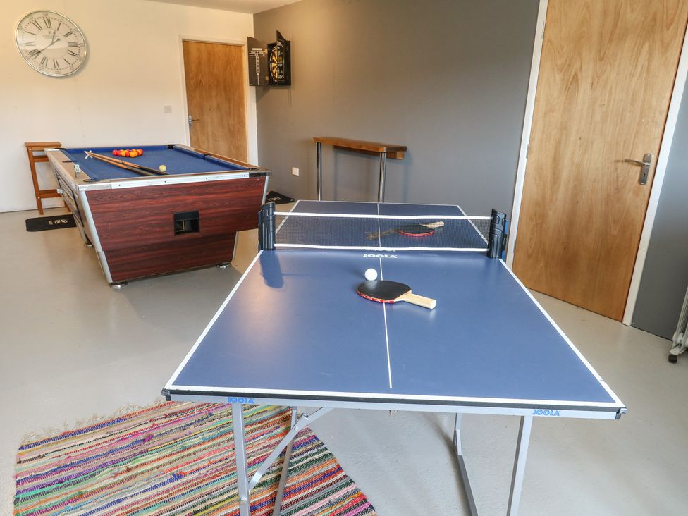 A game room with a ping pong table and billiards table at Tothery in Hooke near Beaminster