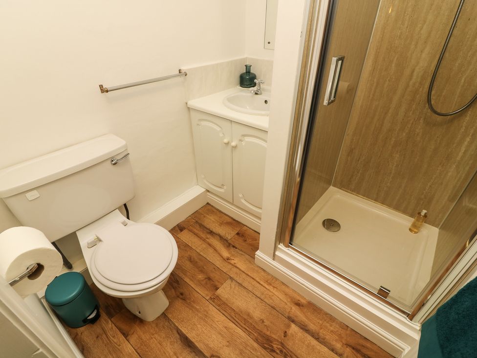 A bathroom with a toilet sink and shower at Whitefriars Lodge in Settle