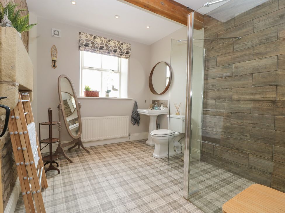 A bathroom with a toilet sink shower and standing mirror at Cuthbert Hill Farm in Chipping