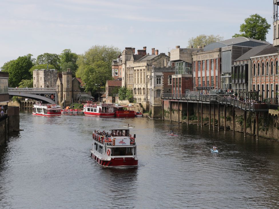 A river with boats and buildings along the waterfront in York